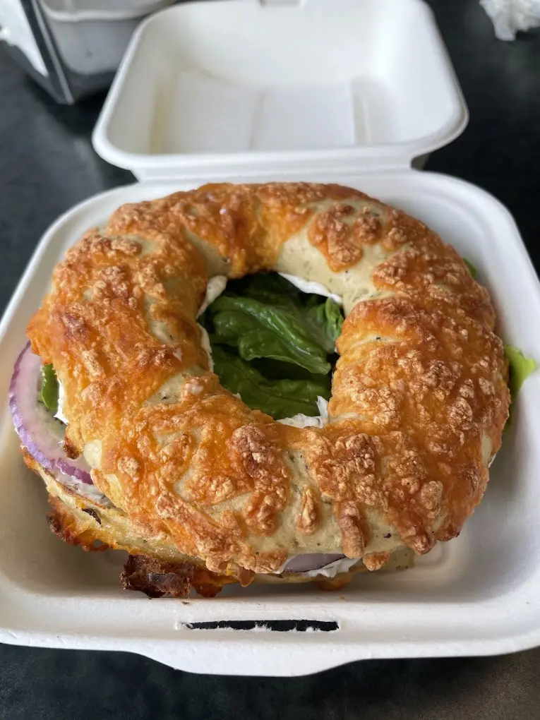 Cheese bagel sandwich in a takeout box