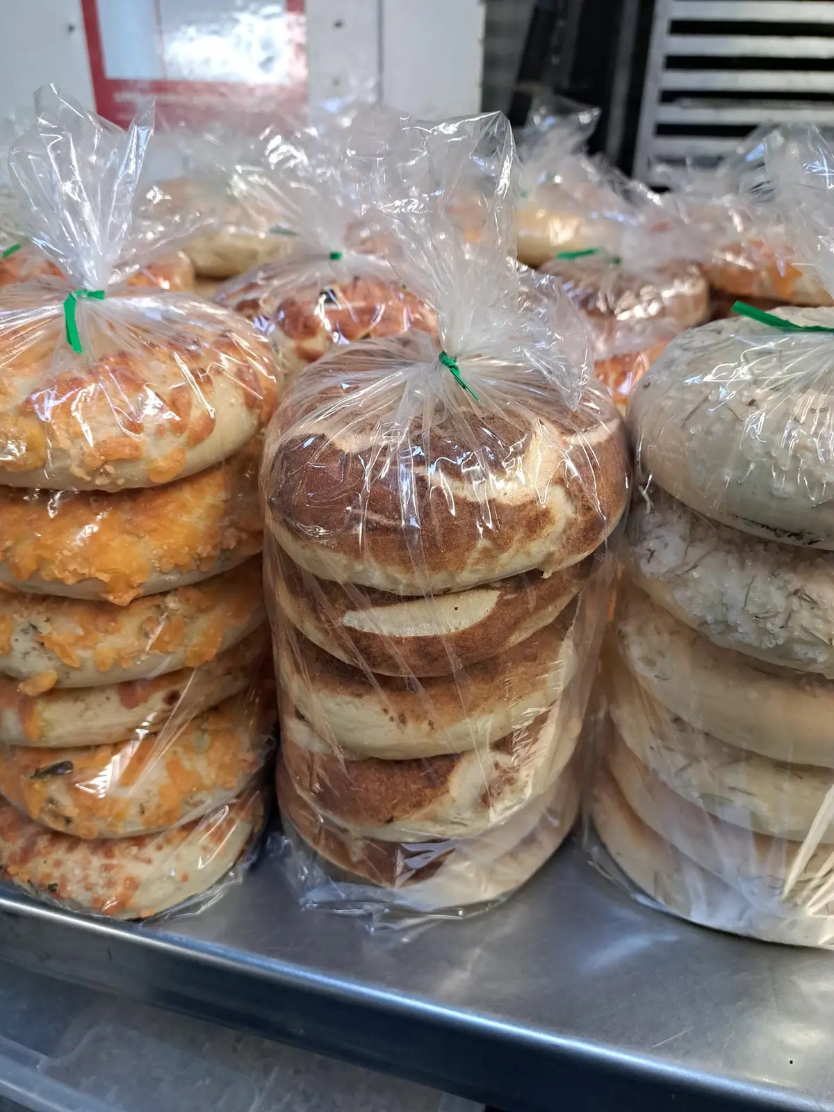 Paper bags of half-dozen bagels ready to go
