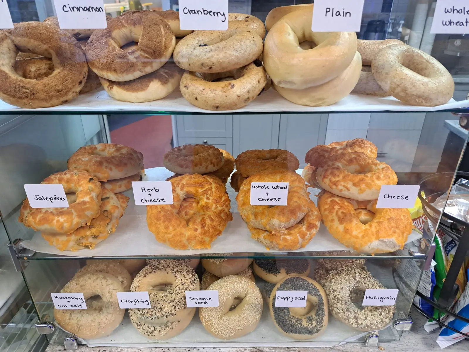 The bagel display case, full of fresh bagels